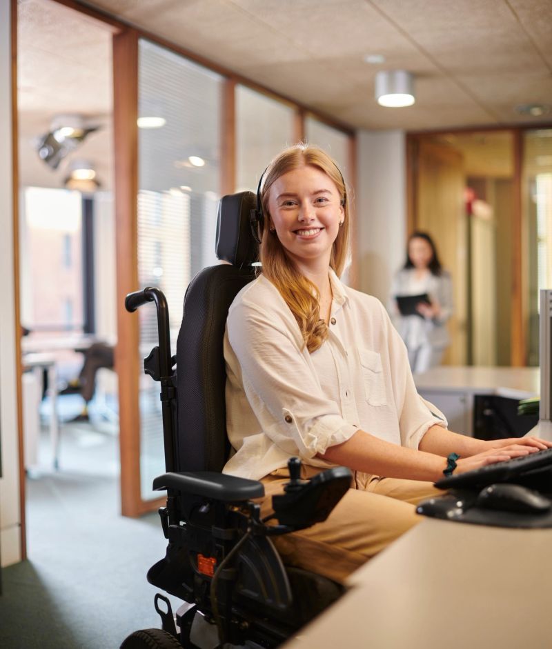 young disabled woman working at her desk in an office