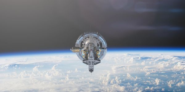 Space shuttle docked to a futuristic space station orbiting Earth.