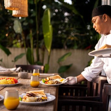 Luxurious office with ocean view, jewelry, and a whiskey glass.