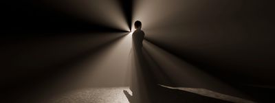 A regal king with a crown raises his hands toward a divine light above.