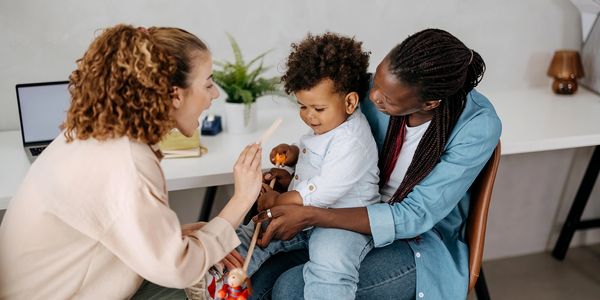Therapist coaching a mother as she plays with her toddler