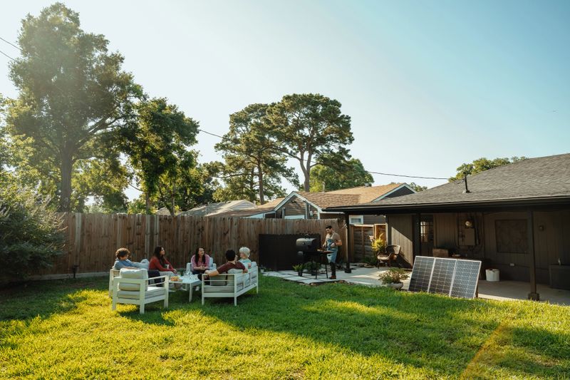 Multi-generation family enjoying barbecue in the backyard at home