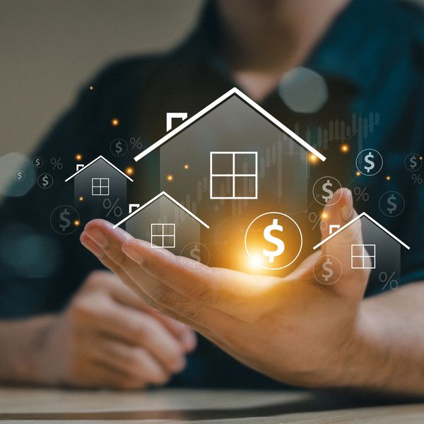 A person holding their hand out with a house in the middle