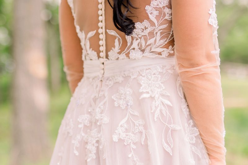 A beautifully designed gown with intricate details displayed against an ethereal backdrop.