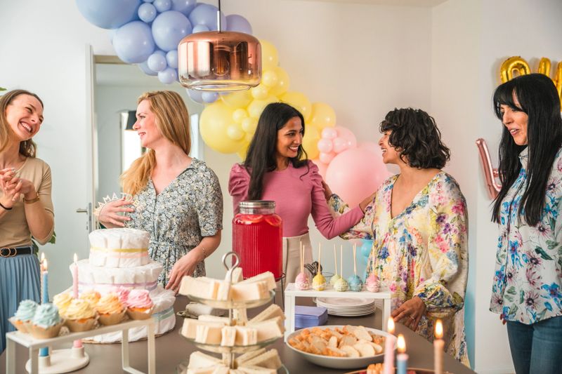A heartwarming surprise at a baby shower for a happy Hispanic expectant mother with her multiethnic friends.