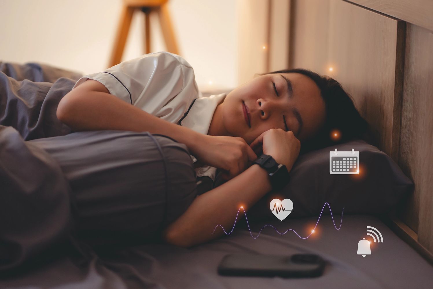 Woman peacefully sleeping with health and calendar icons floating around.