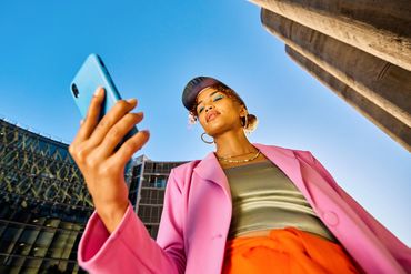 Confident woman taking a selfie outdoors.