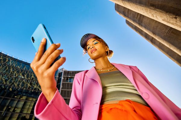 Young woman taking a selfie outdoors.
