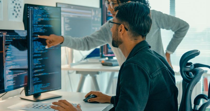 Tech team professionals collaborate discuss software development strategies in modern office. Software developer, artificial intelligence and programming concept.