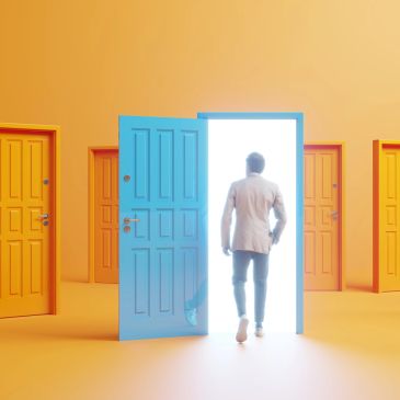 Man walks through a glowing open door among orange doors.