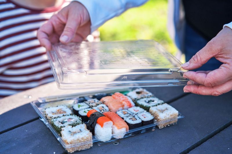 Eating Sushi  from Plastic Packaging Outside