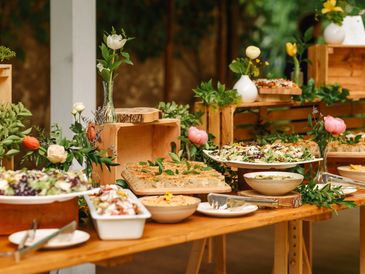 Elegant buffet setup with fresh flowers and various dishes.