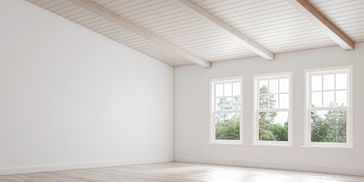 home addition with windows for natural light and beams on ceiling
