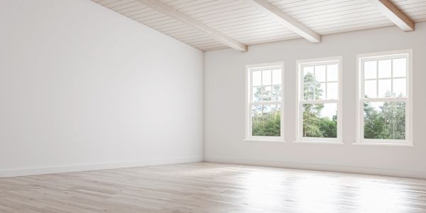 Empty room with white walls and wooden ceiling.