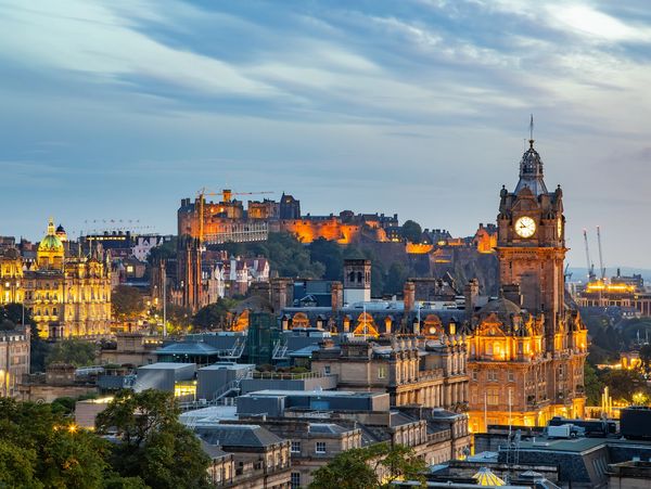 Evening view of Edinburgh city with Edinburgh Castle and clock tower.