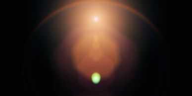 Bright lens flare against dark background.