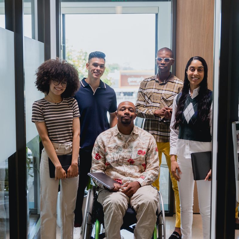 Diverse and Dynamic Business Team Portrait, including one African American man in a wheelchair.