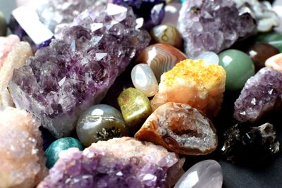 A colorful assortment of polished and raw gemstones and crystals.