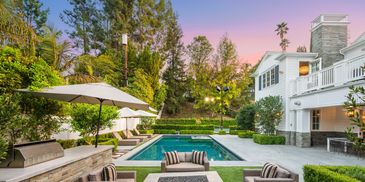 Luxury poolside scene with ocean view.