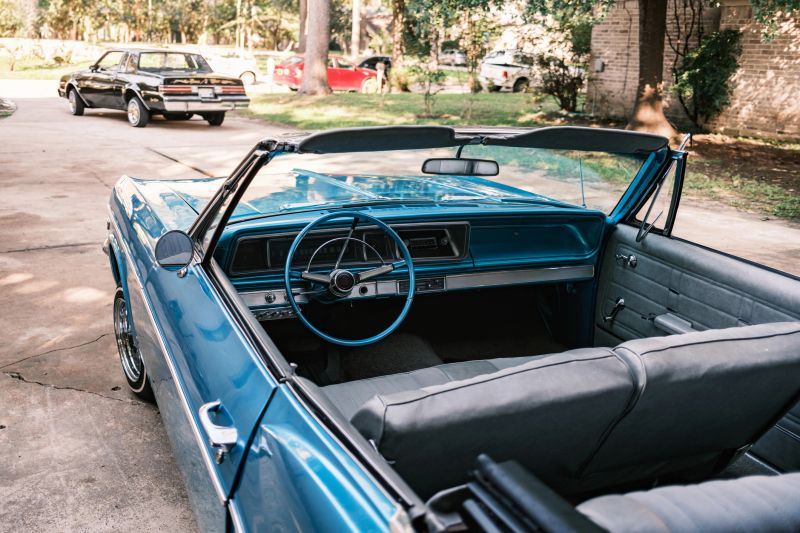 Vintage Low Rider cars parked in the driveway. Exterior of private home in Houston, Texas.
