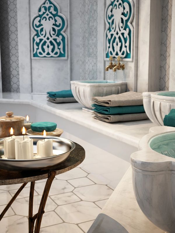 Moroccan hammas sinks and towels with candles lit