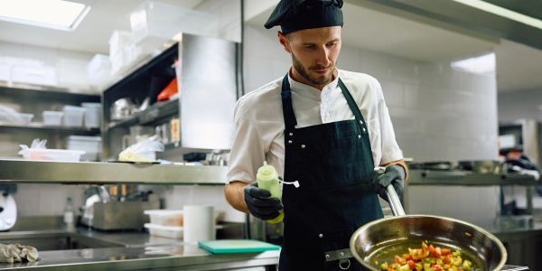 Chef cooking in a professional kitchen.