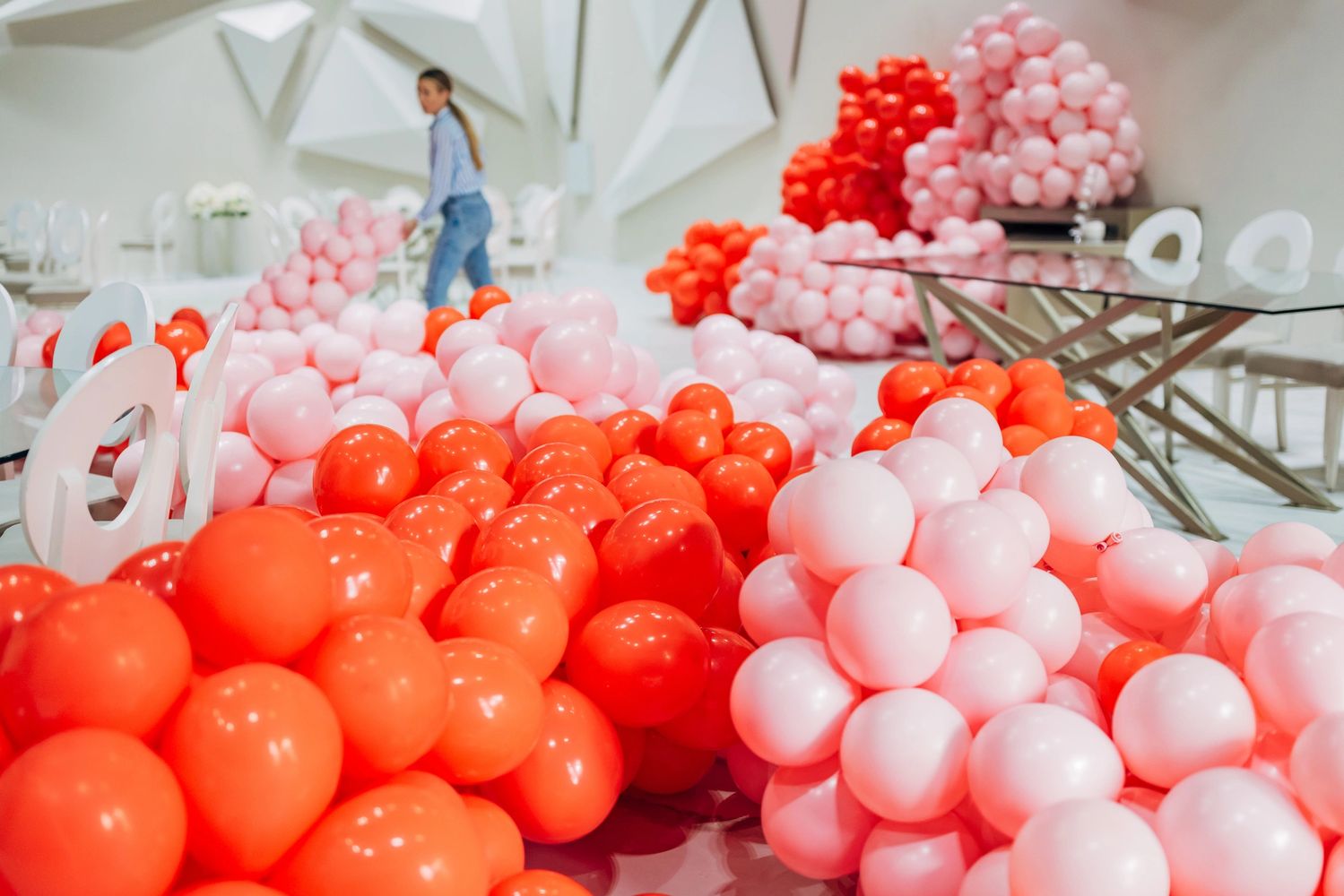 Stack of books next to pencils in a holder and a camera.