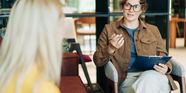 Therapist listening attentively to a patient during a session.