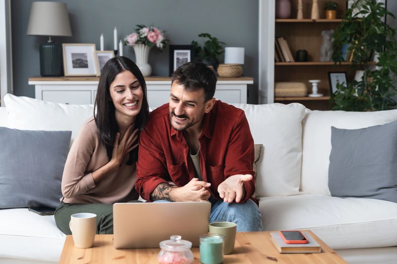 Young couple having video call from home with their psychotherapist, after online therapy for communication problems, relationship difficulties and marriage counseling to say thank you to her for help