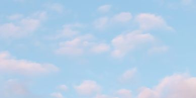 Blue sky with soft clouds.