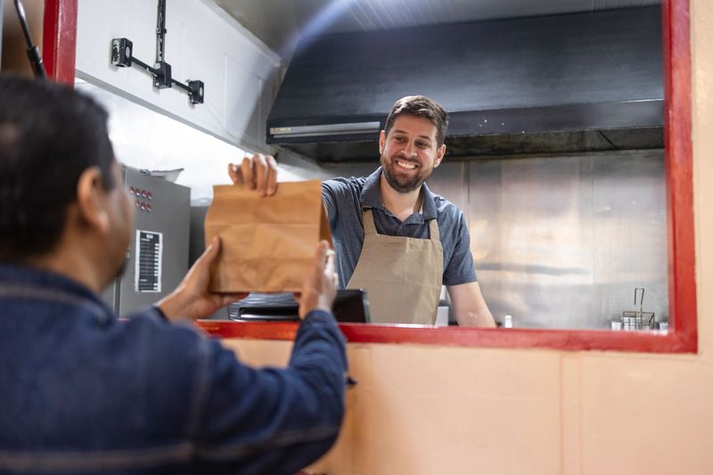 Foodtruck owner delivering ready-made food
