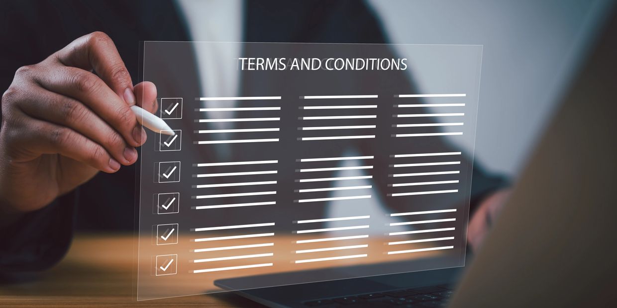 Person reviewing and checking off terms and conditions on a digital transparent screen.