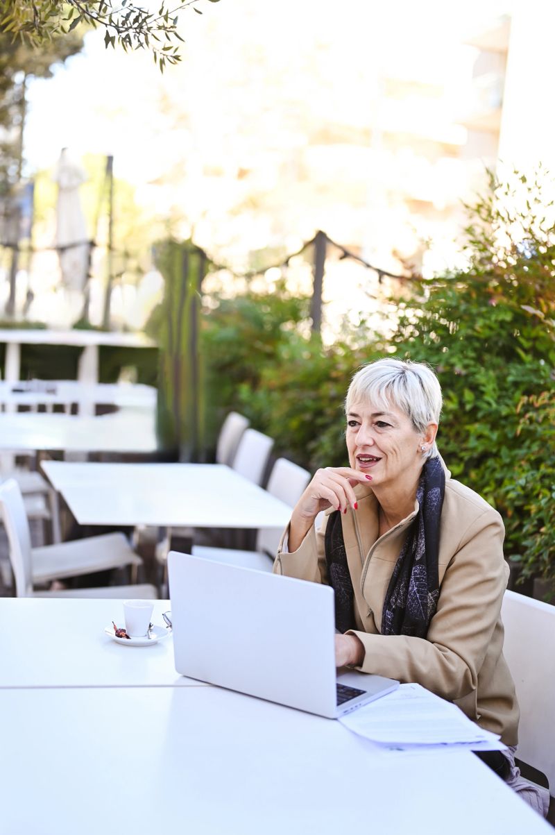 Confident business woman working on laptop.