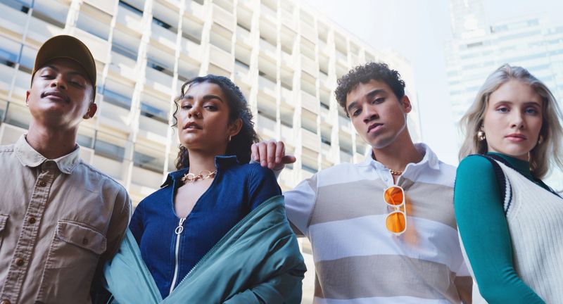 City, fashion and portrait of teen friends outdoor in summer for cool, edgy or trendy style together. Diversity, face or serious with man and woman model group in urban town for street culture