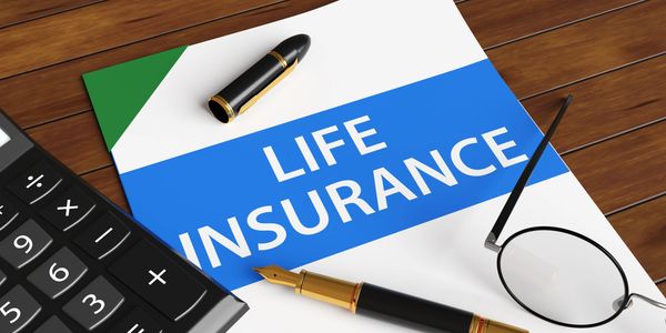 A life insurance document with a pen, glasses, and calculator on a wooden table.