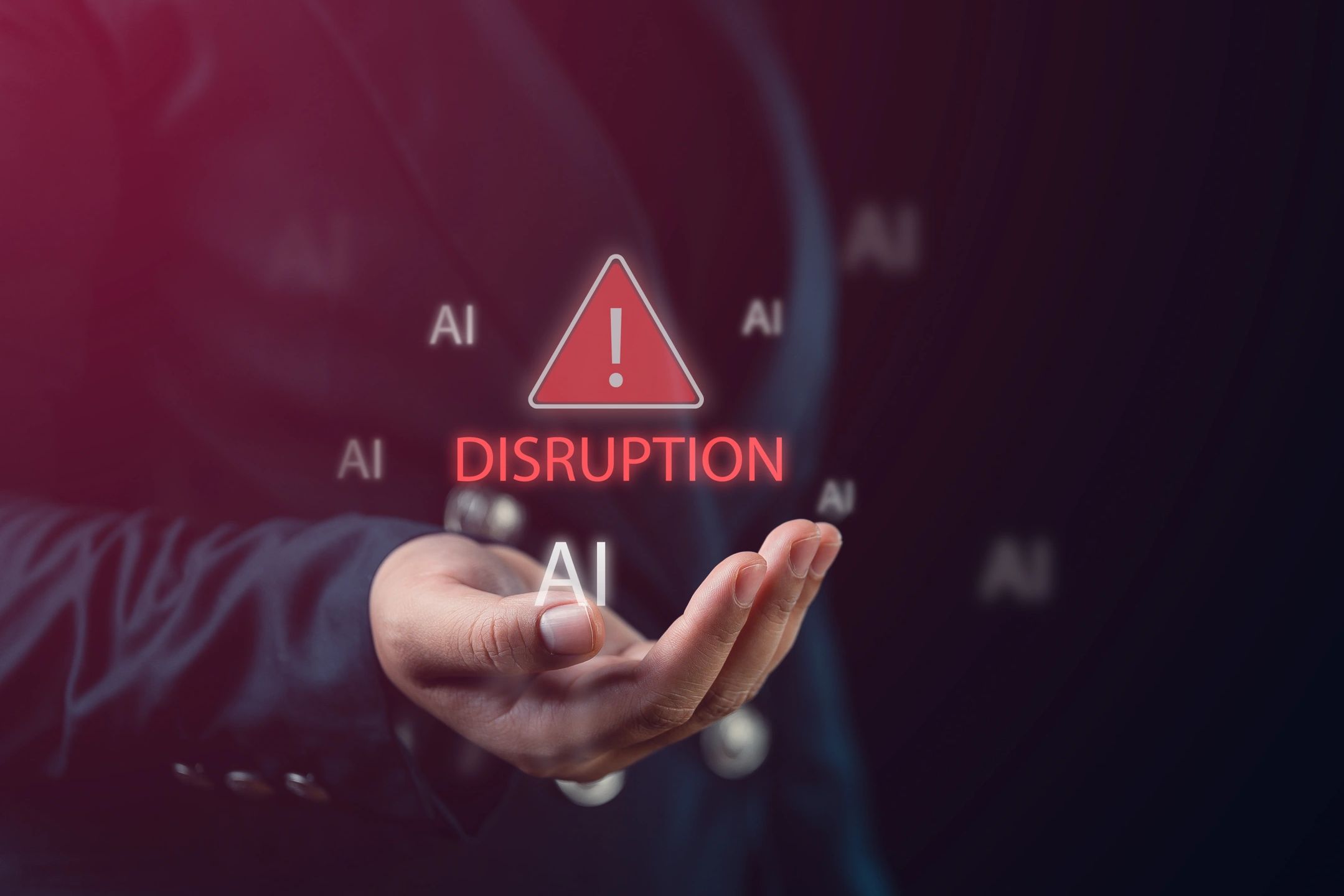 A hand presenting AI disruption warning with a red alert symbol.