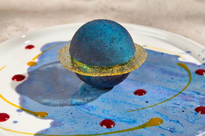 Galaxy-Inspired Mousse Cake in Planet Shape with Summer Sunlight and Shadow Play.