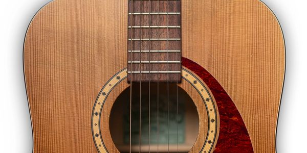 Close-up of an acoustic guitar's sound hole and strings.