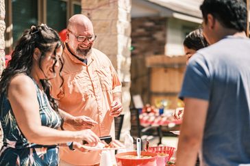 Friends enjoying a sunny outdoor barbecue together.