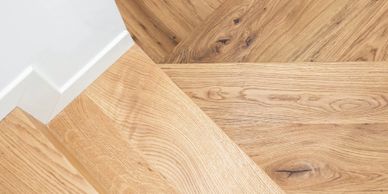 Close-up of wooden stairs and floor with natural grain patterns.