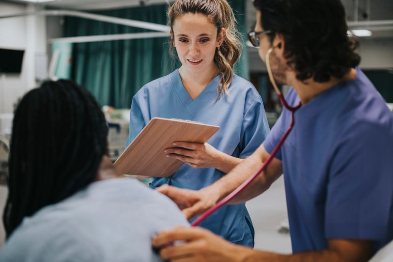 Young male physician examining a patient