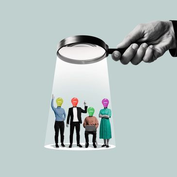 Magnifying glass highlighting people with colorful lightbulb heads symbolizing ideas.