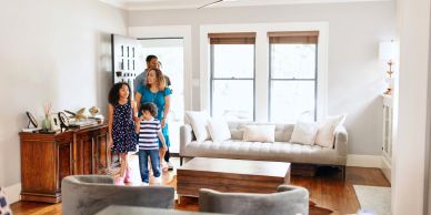 A family exploring a bright living room.