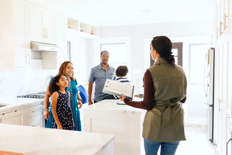 Excited young couple buying a new house for their family