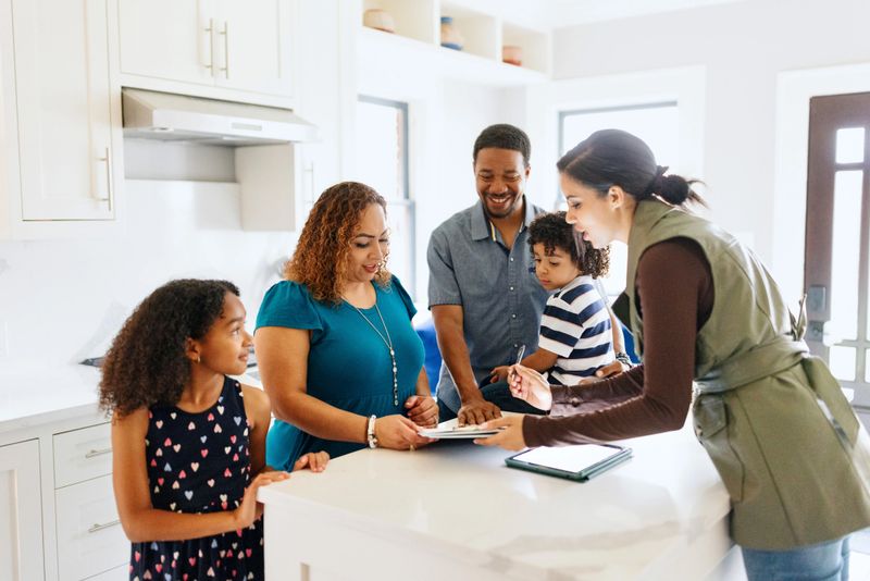 Real estate agent helping her clients with an agreement