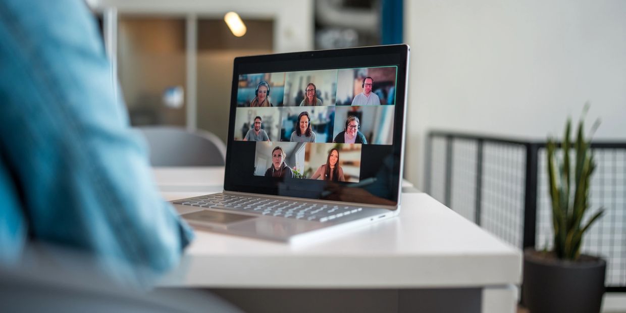 Person attending a virtual meeting on a laptop.