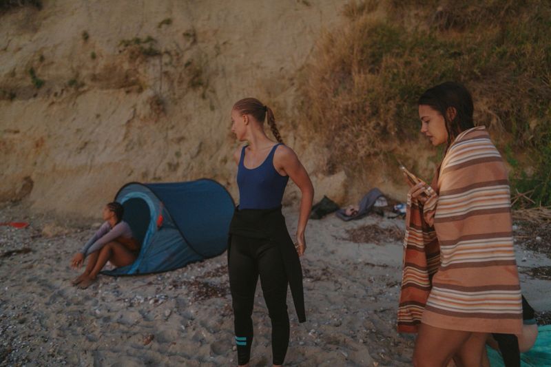 Photo of a couple of female friends camping on the beach by the sea