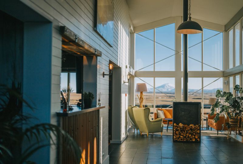 Cozy luxury tourist resort lounge area with fireplace in the morning with snowcapped mountain background