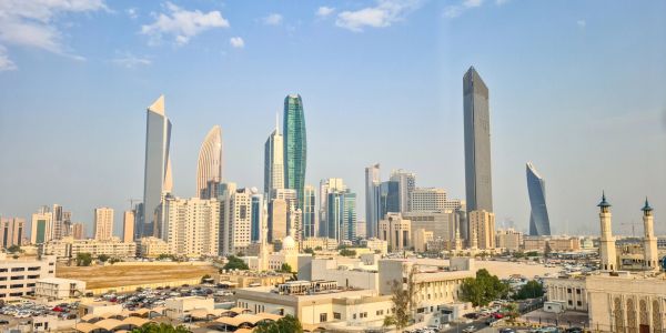 Modern city skyline with unique skyscrapers under a clear blue sky.