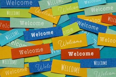 Colorful cards with 'Welcome' text scattered.